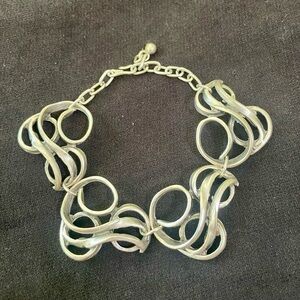 Silver tone bracelet with adjustable closure